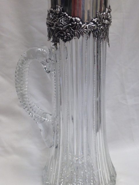 a silver claret jug with the glass bottle replaced and re-cut to match original